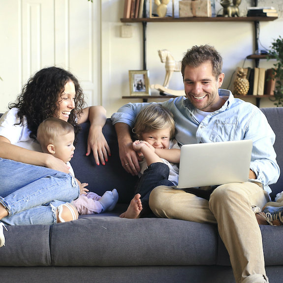 family sat on a sofa